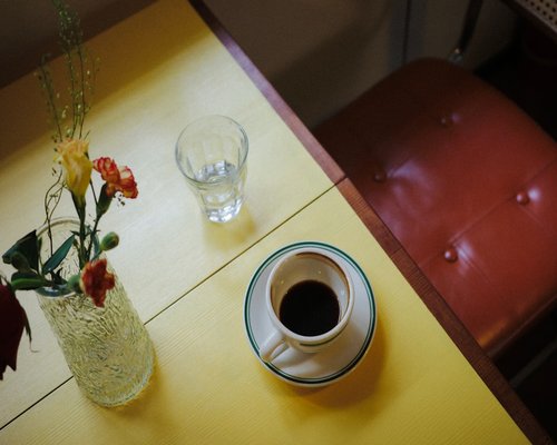 Glass of water and a coffee cup on a wooden table